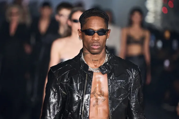A high-fashion runway scene with Travis Scott.