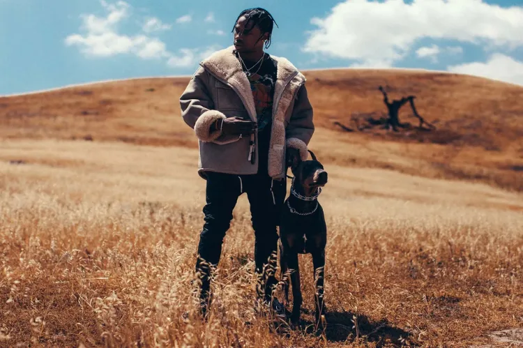 A dramatic scene showing Travis Scott