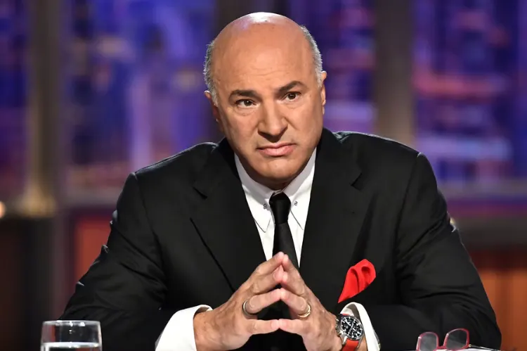 A professional, high-resolution editorial-style portrait of Kevin O’Leary in a dark tailored suit