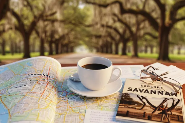 Savannah weekend itinerary concept with open map, coffee cup, travel guide, oak trees in background