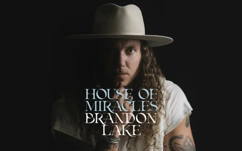 Album artwork for "House of Miracles" by Brandon Lake, featuring a portrait of the musician in a wide-brimmed hat against a dark background