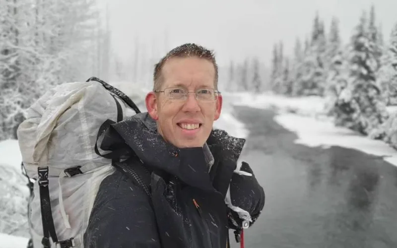 luke nichols with bagpack in snow